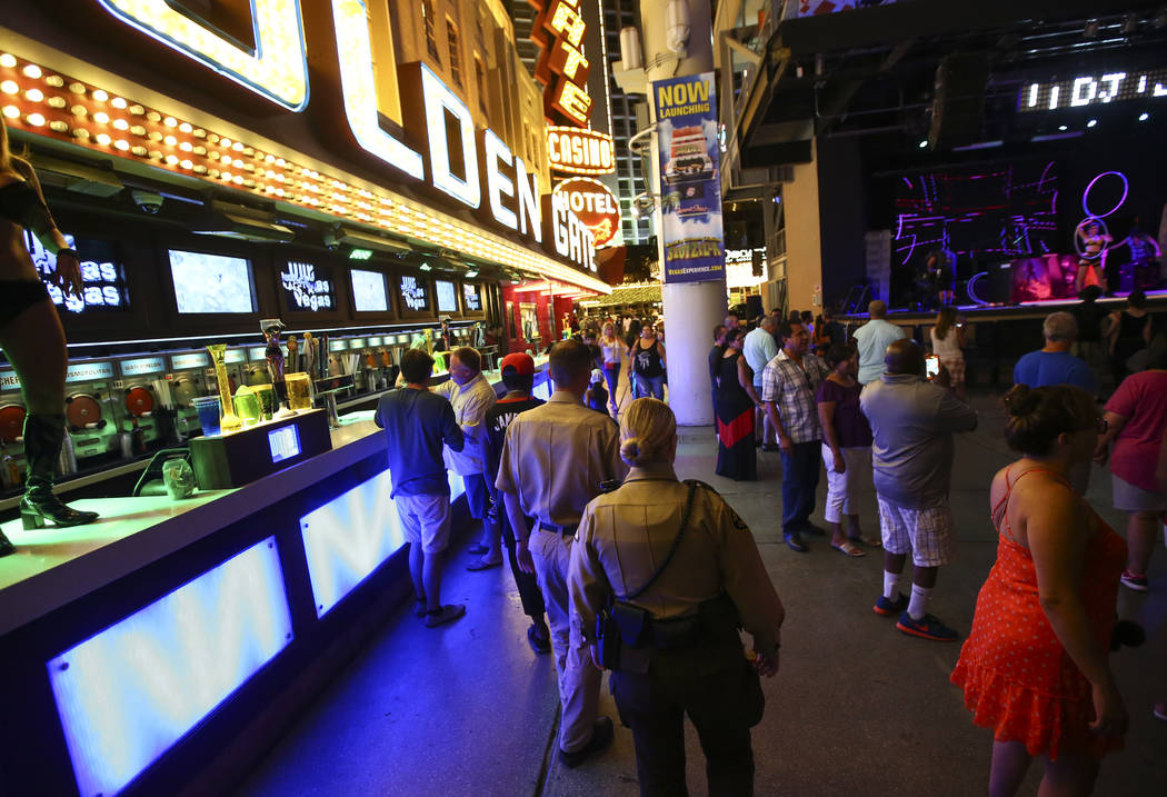 Security officers patrol along the Fremont Street Experience in downtown Las Vegas on Tuesday, Aug. 1, 2017. Chase Stevens Las Vegas Review-Journal @csstevensphoto