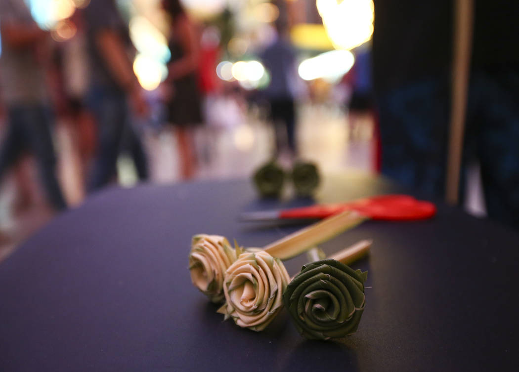 Roses made from palm tree fronds are one of many things buskers offer to tourists along the Fremont Street Experience in downtown Las Vegas on Tuesday, Aug. 1, 2017. Chase Stevens Las Vegas Review ...