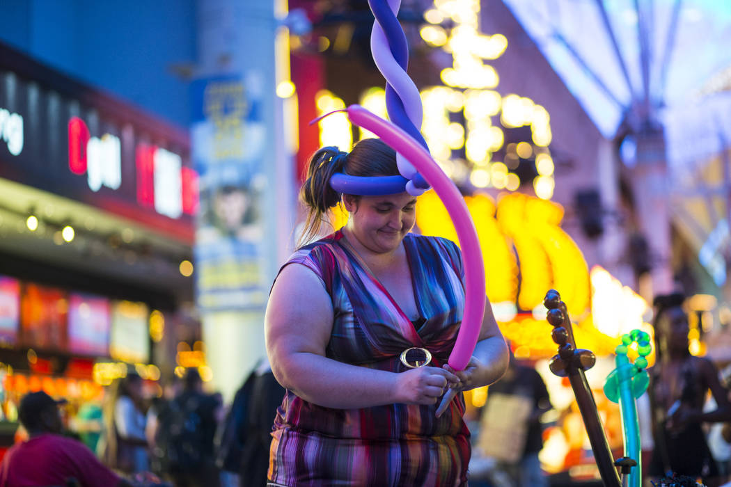 Balloon artist Heather Baressi, one of many buskers who offer a variety of items to tourists along the Fremont Street Experience, in downtown Las Vegas on Wednesday, Aug. 2, 2017. Chase Stevens La ...