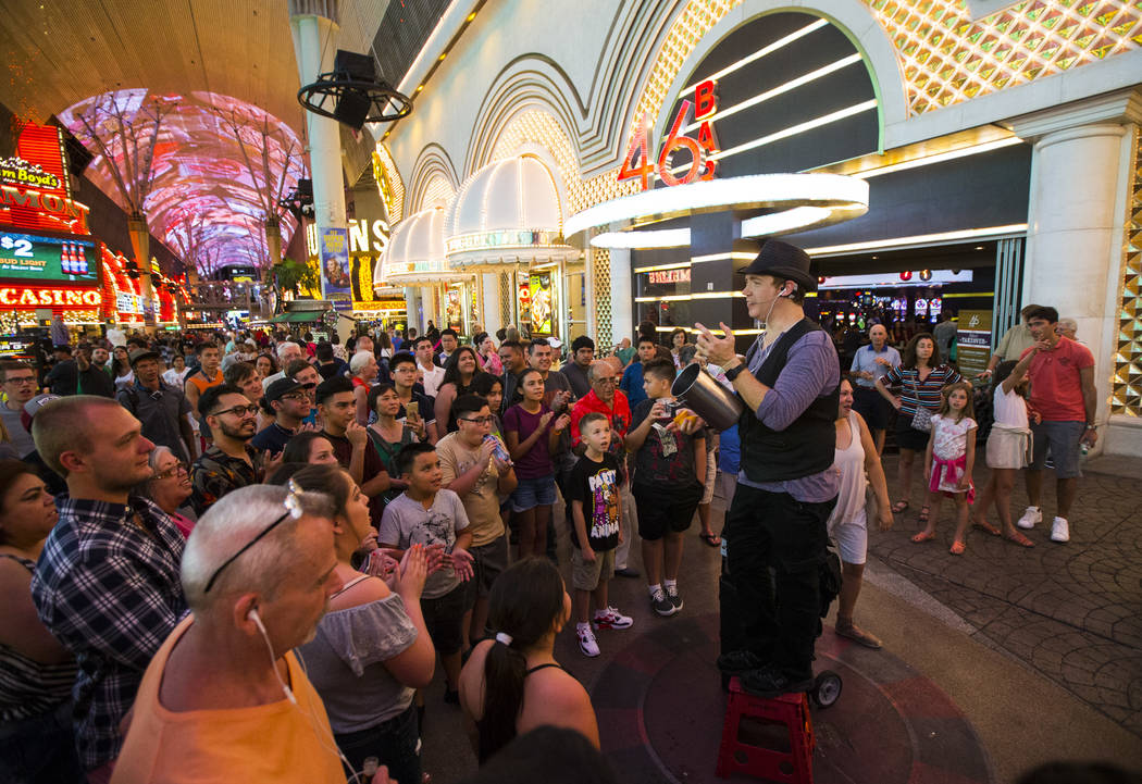 Magician Sean Scott performs along the Fremont Street Experience in downtown Las Vegas on Tuesday, Aug. 1, 2017. Chase Stevens Las Vegas Review-Journal @csstevensphoto