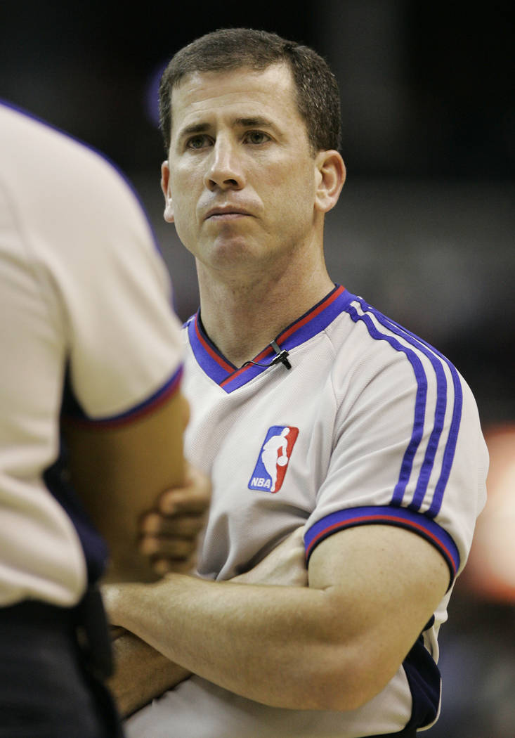 NBA official Tim Donaghy talks with another official during a timeout during a Washington Wizards New Jersey Nets basketball game, Tuesday, April 10, 2007 in Washington. For NBA referees, the job  ...