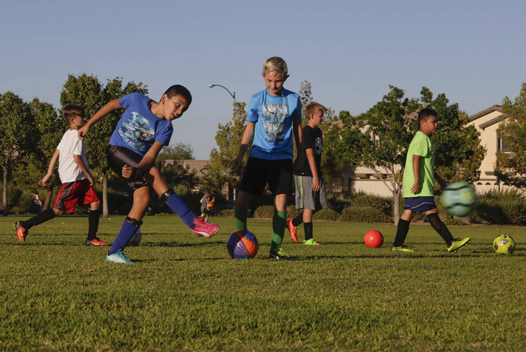 Members of the U-12 boy's team, The Dragons, who are a part of the Southern Nevada Soccer Association, practice in the corner of Inzalaco Park in Las Vegas, on Thursday, Aug. 24, 2017.  Gabriella  ...