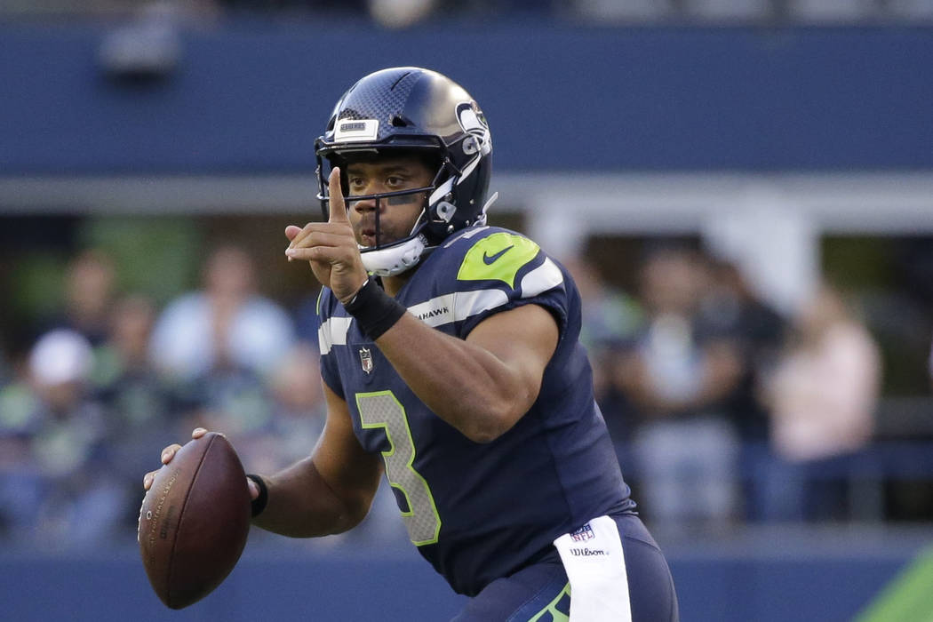 Seattle Seahawks quarterback Russell Wilson looks to pass against the Kansas City Chiefs in the second half of an NFL football preseason game, Friday, Aug. 25, 2017, in Seattle. (AP Photo/Elaine T ...
