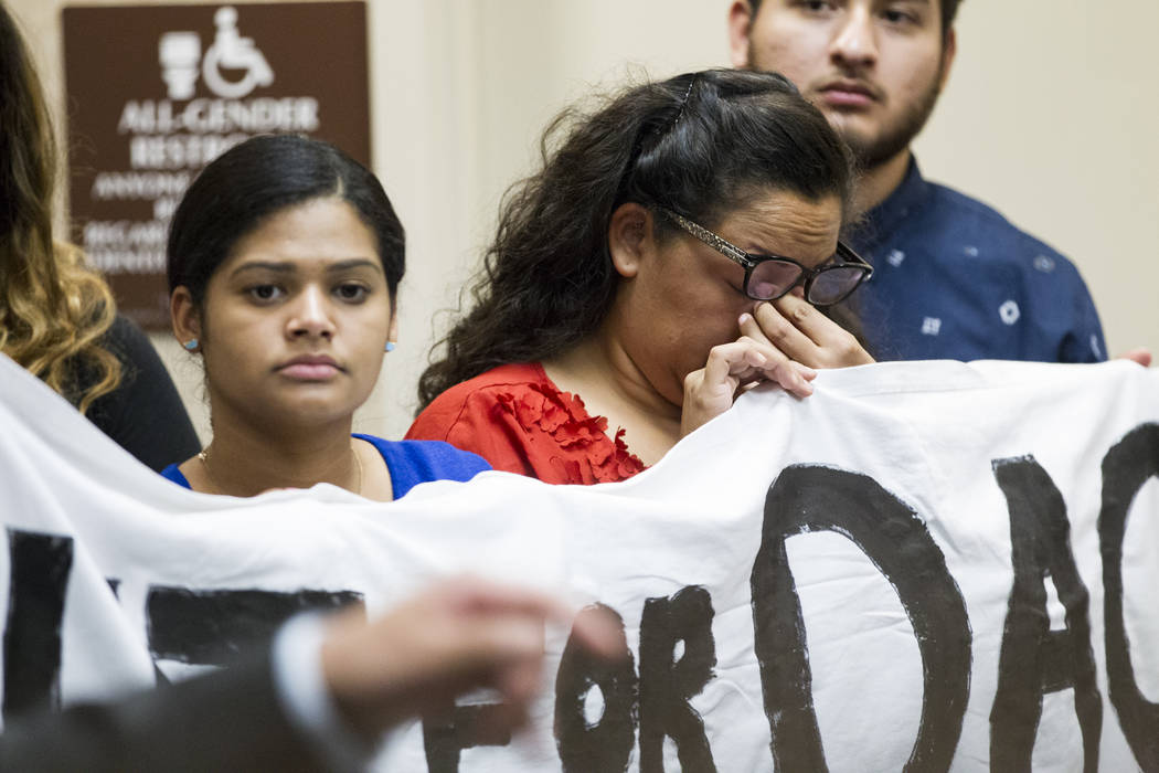 Kenia Morales, center, a supporter of the Deferred Action for Childhood Arrivals program, reacts during a press conference on the cancellation of DACA at the East Las Vegas Community Center, in La ...