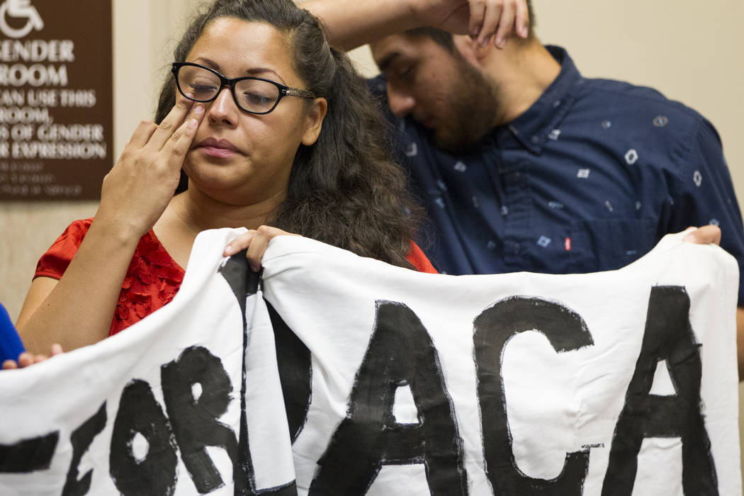 Kenia Morales, left, a supporter of the Deferred Action for Childhood Arrivals program, reacts during a press conference on the cancellation of DACA at the East Las Vegas Community Center, in Las  ...