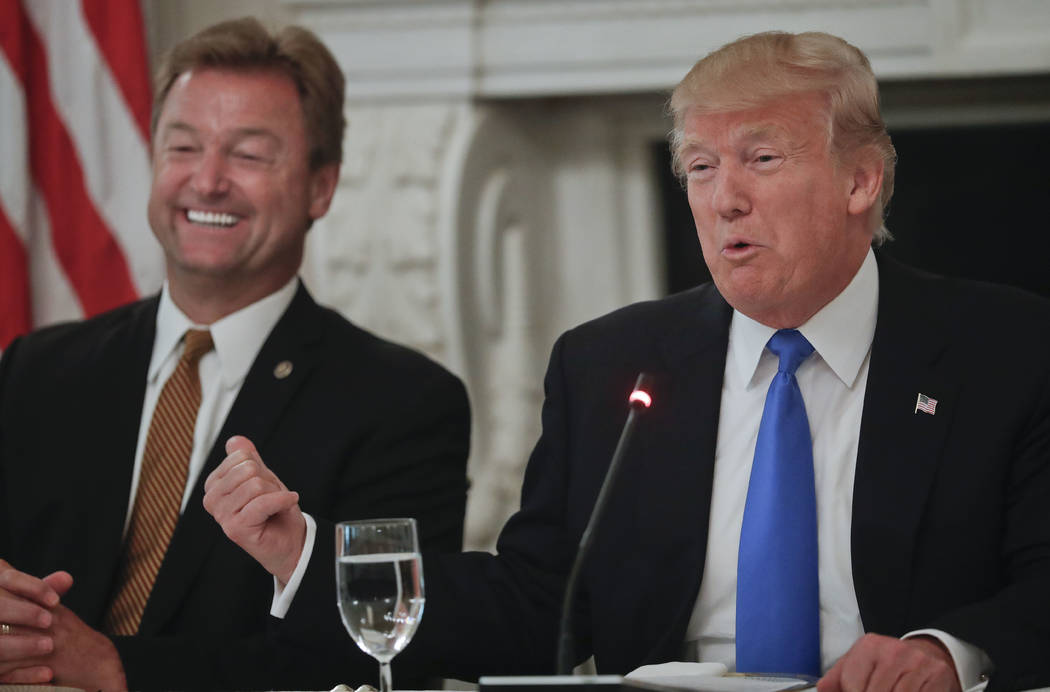 President Donald Trump gestures towards Sen. Dean Heller, R-Nev. while speaking during a luncheon GOP leadership, Wednesday, July 19, 2017, in the State Dinning Room of the White House in Washingt ...