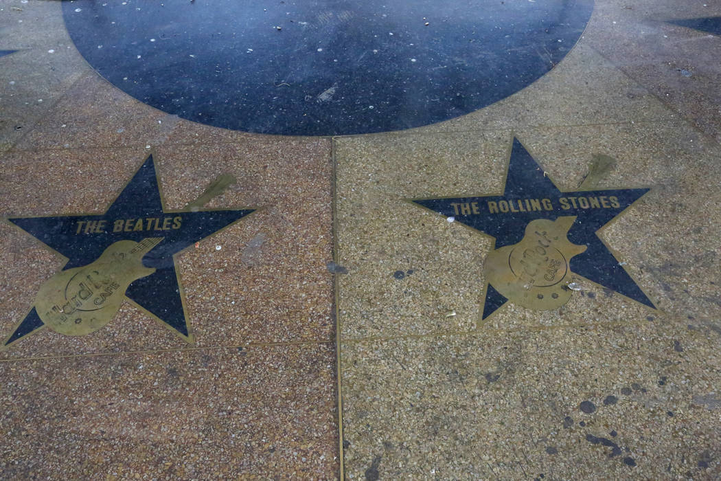 Stars with popular bands are embedded at the entrance to the Hard Rock Café at the corner of Harmon and Paradise on Friday, September 1, 2017. Its iconic neon sign is being moved to a new hom ...
