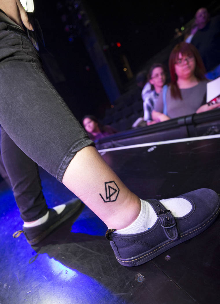 Linkin Park fan Jenn Pauch of Los Angeles shows her LP tattoo during a memorial for the band's singer Chester Bennington at Saxe Theater on Saturday, Sept. 2, 2017, in Las Vegas. Linkin Park cance ...