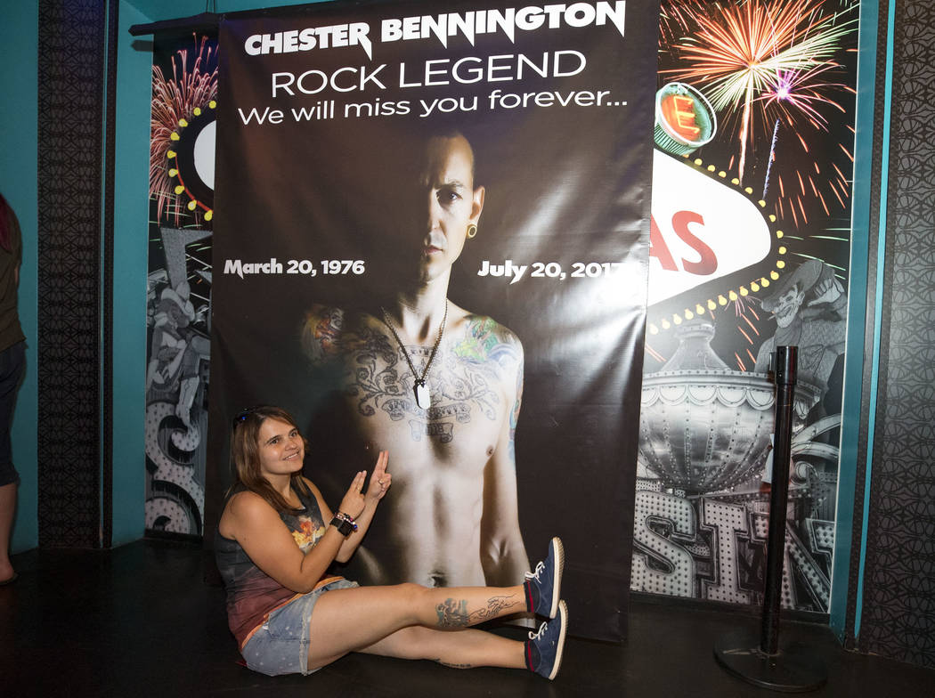 Olga Petrosova of Russia poses with a banner of singer and songwriter Chester Benningtona during memorial for Bennington at Saxe Theater on Saturday, Sept. 2, 2017, in Las Vegas. Linkin Park cance ...