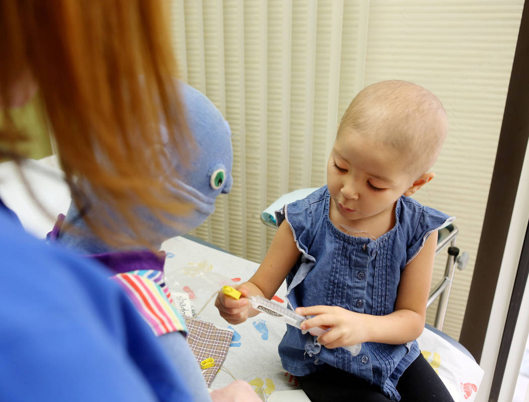Leukemia patient Madilyn Cash, 4, treats her shadow buddy doll at the Children's Specialty Center of Nevada in Las Vegas, Tuesday, Sept. 5, 2017. Shadow buddies are used to help patients cope and  ...