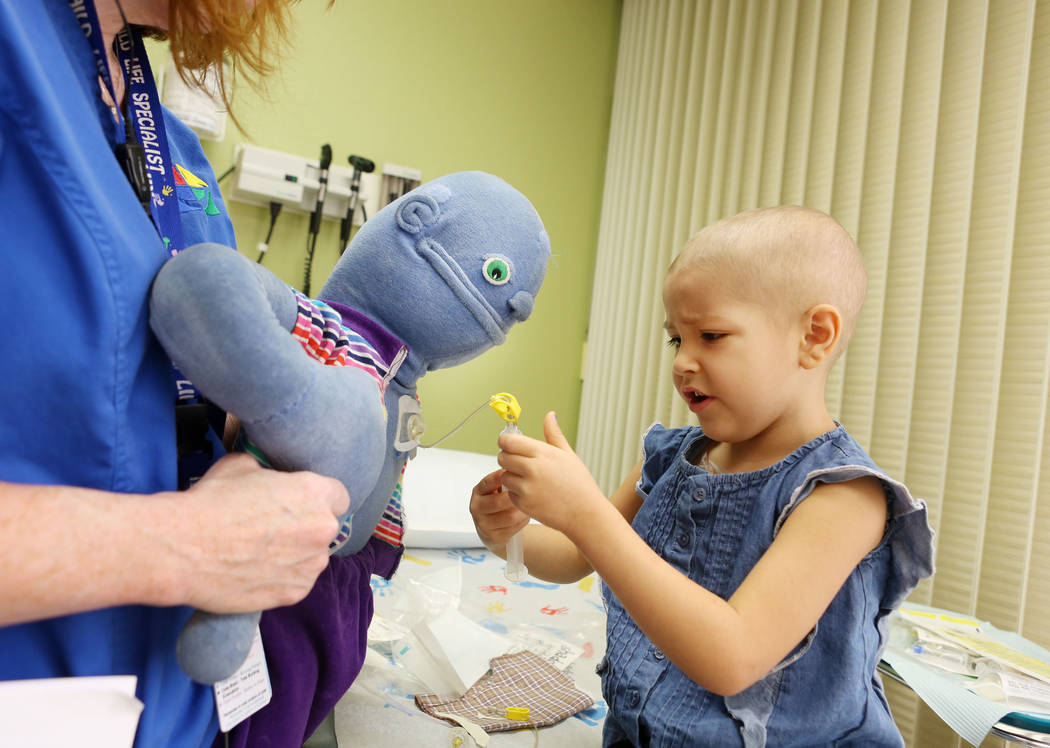 Leukemia patient Madilyn Cash, 4, treats her shadow buddy doll at the Children's Specialty Center of Nevada in Las Vegas, Tuesday, Sept. 5, 2017. Shadow buddies are used to help patients cope and  ...