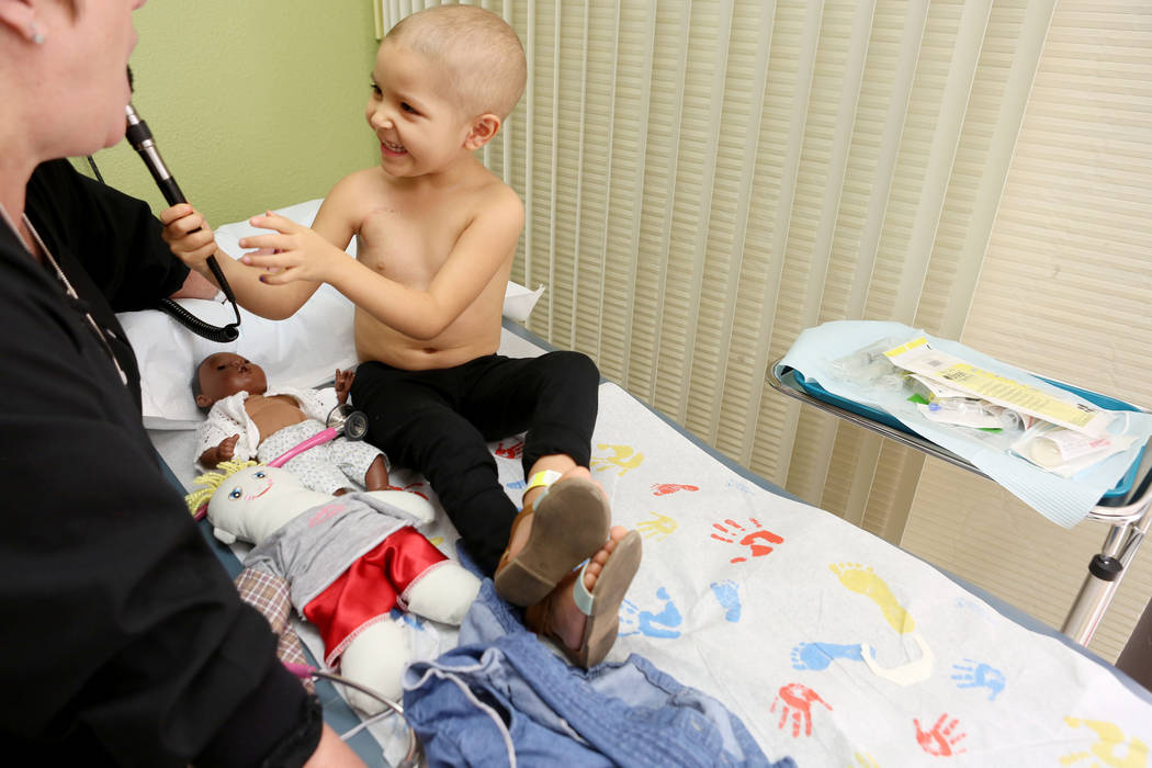 Leukemia patient Madilyn Cash, 4, checks Nurse Practitioner Arlene Bayreder's ears at the Children's Specialty Center of Nevada in Las Vegas, Tuesday, Sept. 5, 2017. Elizabeth Brumley Las Vegas Re ...