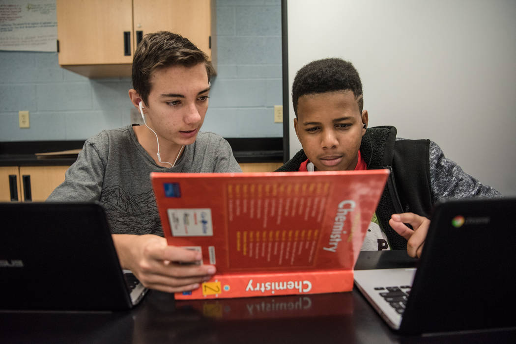 Shadow Ridge High School sophomores Anthony Mastaler, left, and Malachi Banks, right, look at the periodic table of elements during their chemistry class at the school on Wednesday, Sep. 6, 2017,  ...