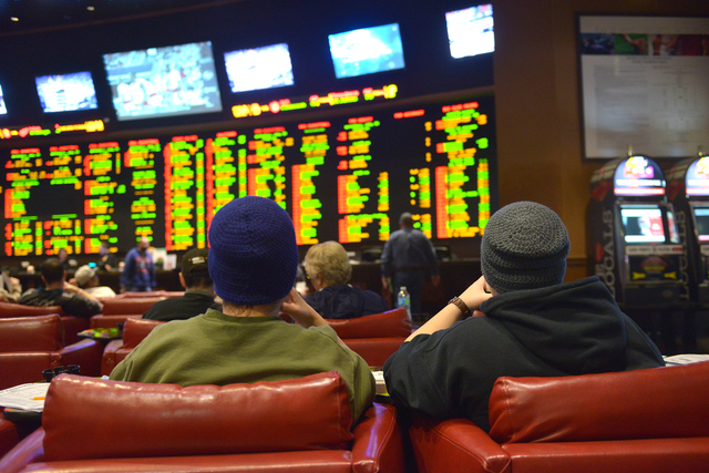 Gamblers sit in the sports book at Sunset Station casino in Henderson on Jan. 31, 2015. A regulation that will allow Nevada sports books to accept wagers on the Olympics was recommended for approv ...