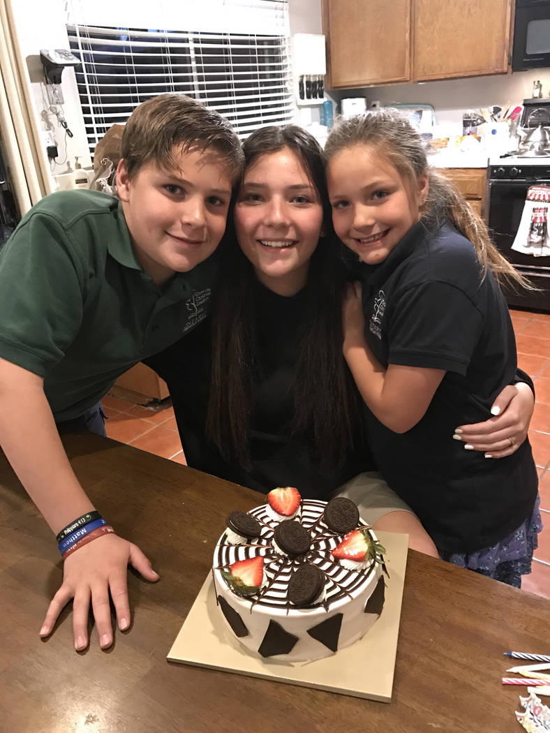 Micaela Miller, 16, center, Noah Miller,12, left, and Madison Miller, 8, made a cake for their late mother Sheila Miller on her birthday on March 1, 2017. Both parents died in a car crash in 2010. ...