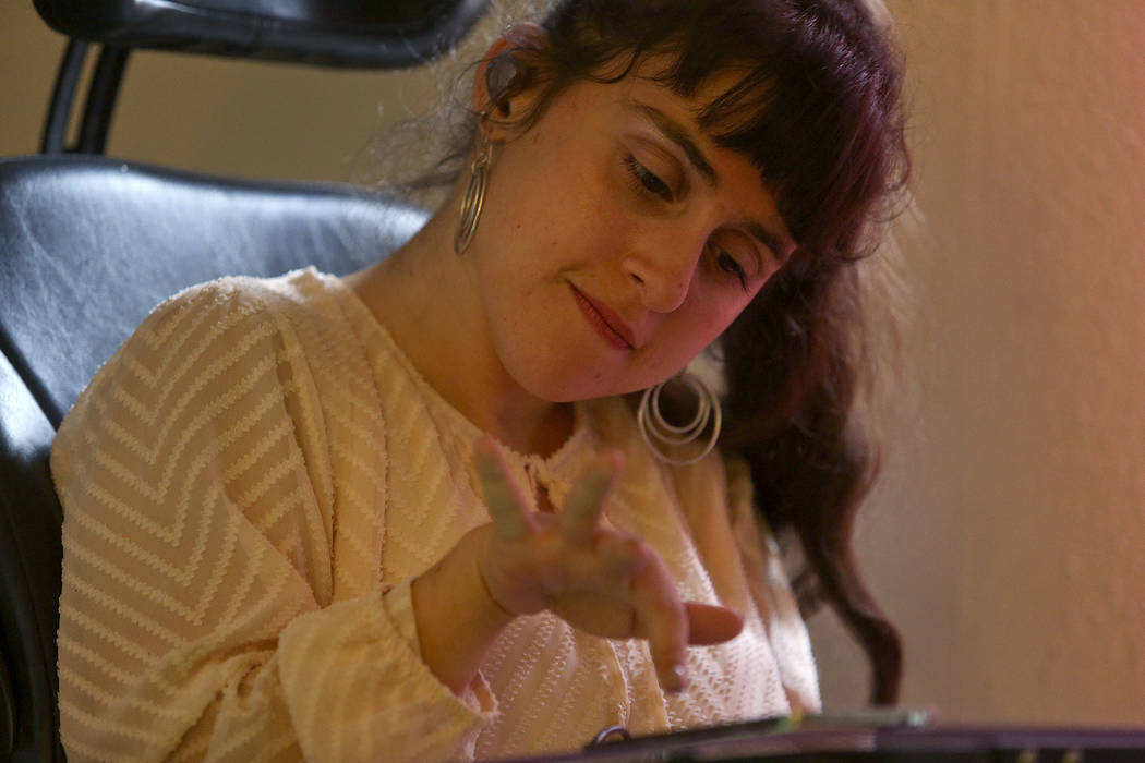 Sharona Dagani types on her phone at her home in San Antonio, Texas on Sunday, March 12, 2017. The 29-year-old Dagani, born with cerebral palsy, is one of hundreds of former clients of jailed esta ...