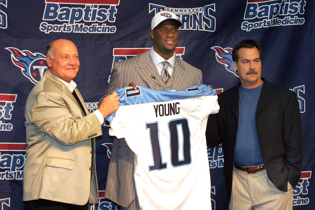 Former Texas quarterback Vince Young who was the third overall pick in the first round of the NFL Draft selected the Tennessee Titans is pictured holding a Titans jersey with Titans general manage ...