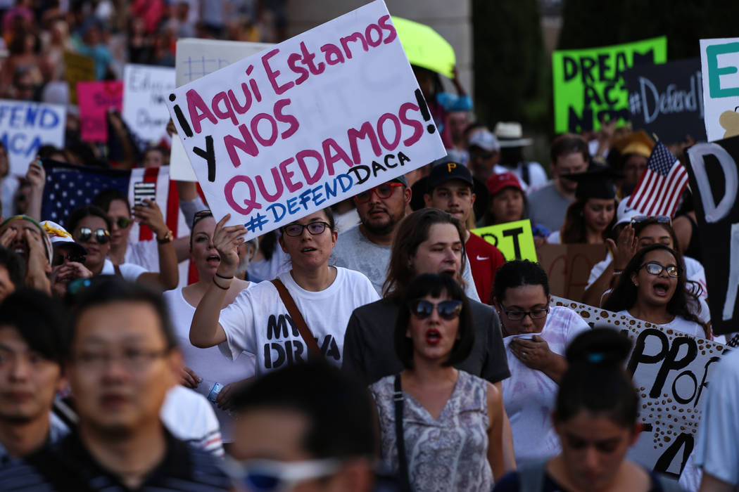 Several hundred DACA recipients and supporters including Maria Garcia De Los Santos, center, march down the Strip in Las Vegas, Sunday, Sept. 10, 2017, to call on President Donald Trump and Nevada ...