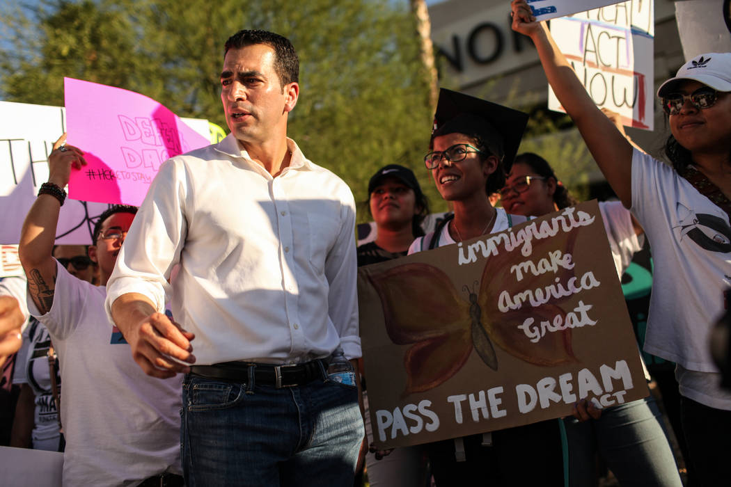 Several hundred DACA recipients and supporters including Rep. Ruben J. Kihuen, left, and UNLV graduate Marcela Rodriguez Campo, right,  march down the Strip in Las Vegas, Sunday, Sept. 10, 2017, t ...