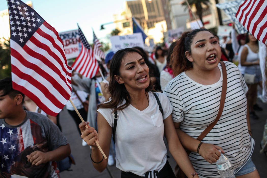 Several hundred DACA recipients and supporters including Lizbeth Godoy-Lua, left, and Graciela Zamarripa, right, march down the Strip in Las Vegas, Sunday, Sept. 10, 2017, to call on President Don ...