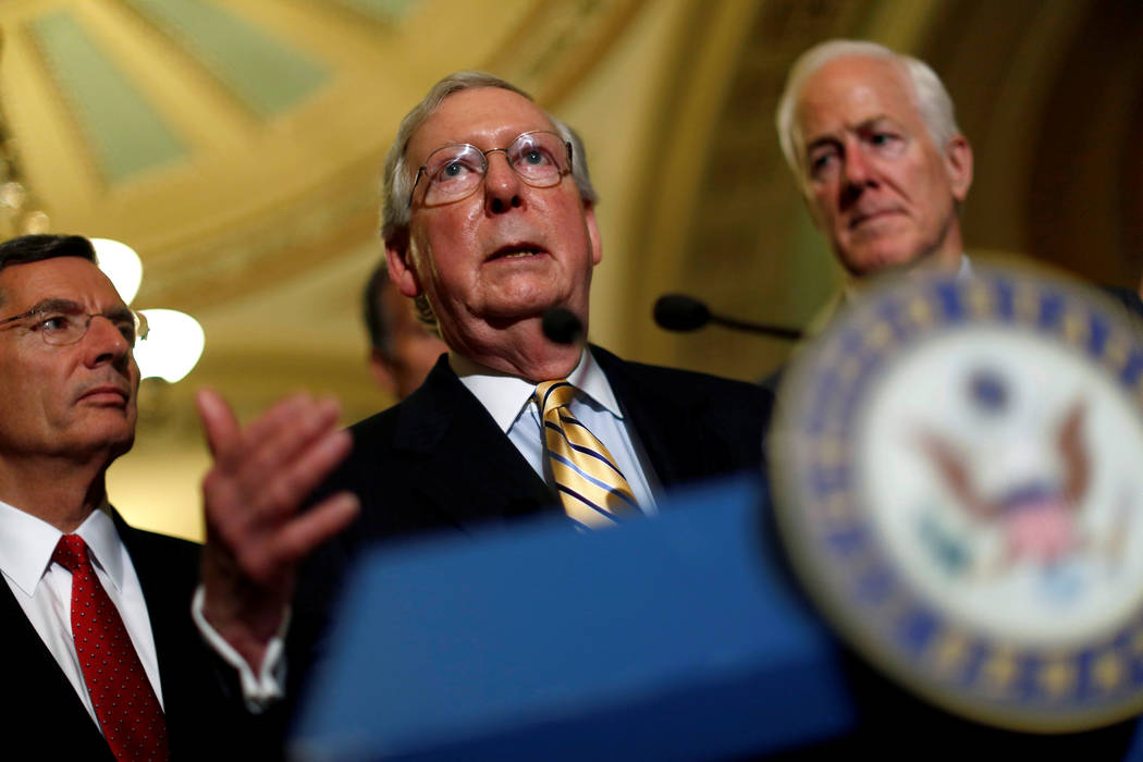 Senate Majority Leader Mitch McConnell, accompanied by Senator John Cornyn (R-TX) and Senator John Barrasso (R-WY), speaks with reporters following the successful vote to open debate on a health c ...