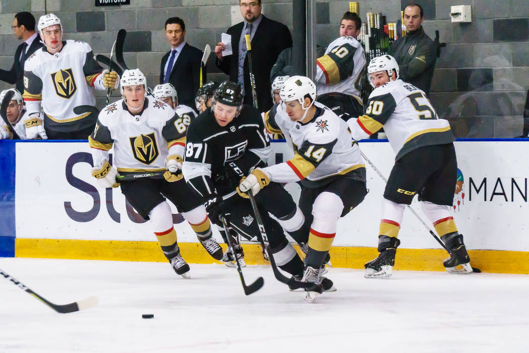 Golden Knights defenseman Nicolas Hague(14) and Los Angles Kings forward Shane Walsh(87) battle for the puck during a rookies' hockey game in El Segundo, Calf., Wednesday, Sept. 13, 2017. The Gold ...