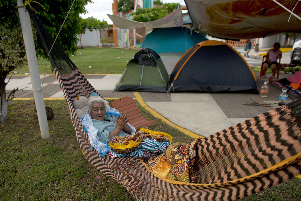 Manuela Lopez, 80, awakens in her hammock, at a technology school where people were sheltering after their homes were destroyed or damaged in Thursday's magnitude 8.1 earthquake, in Juchitan, Oaxa ...