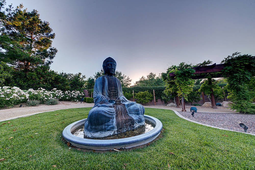 The adjacent lot to the Southern Highlands home was made into a private park, which includes walking and running trails and a Zen garden with a statute of Buddah. (The Napoli Group)