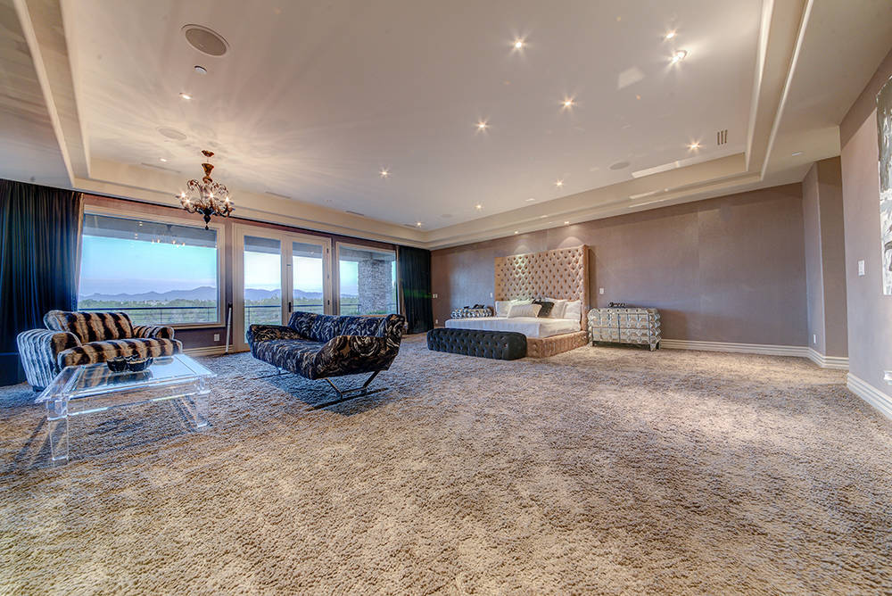 The Large master bedroom has wool carpet and a balcony overlooking the Southern Highlands golf course. (The Napoli Group)