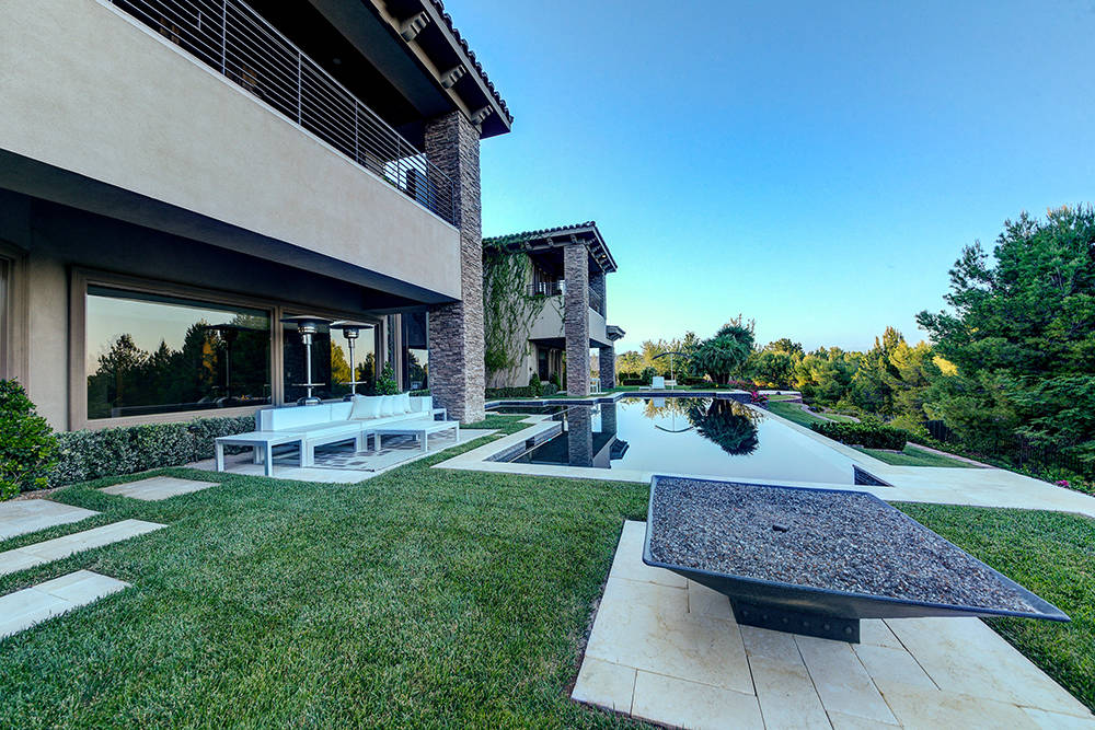 Outside, the home has  an infinity-edge pool and fire features.  (The Napoli Group)