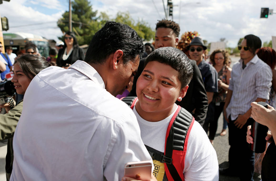 Rancho high school world history teacher and Democratic Congressional candidate Reuben D'Silva, left, encourages high school student Rachel Diaz, 16, after they spoke at a rally in support of the  ...