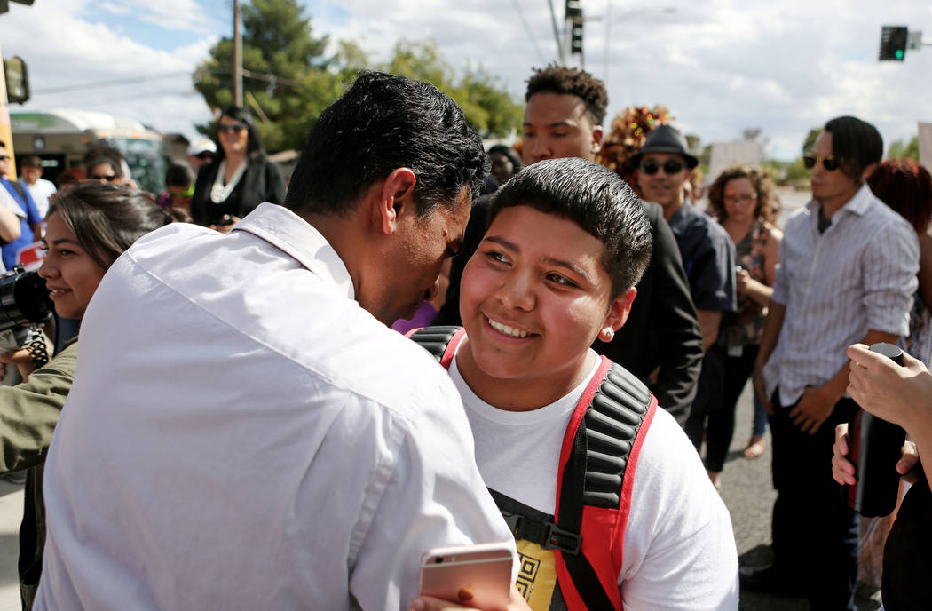 Rancho high school world history teacher and Democratic Congressional candidate Reuben D'Silva, left, encourages high school student Rachel Diaz, 16, after they spoke at a rally in support of the ...