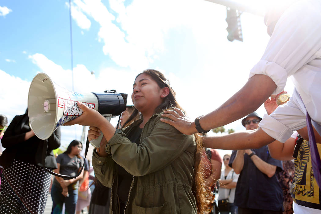 High school student Catherine Soso, 16, is comforted while passionately speaking about her family and friends affected by the removal of Data during a rally in support of the DREAM Act, at Rancho  ...