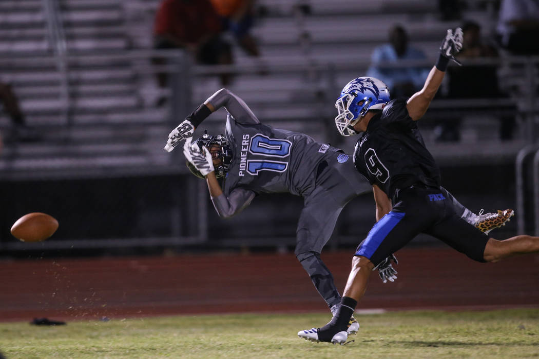Canyon Springs' Keyon White (10) is blocked by Basic's Daniel Paonessa (9) during the second quarter of a football game at Basic High School in Henderson, Friday, Sept. 15, 2017. Joel Angel Juarez ...