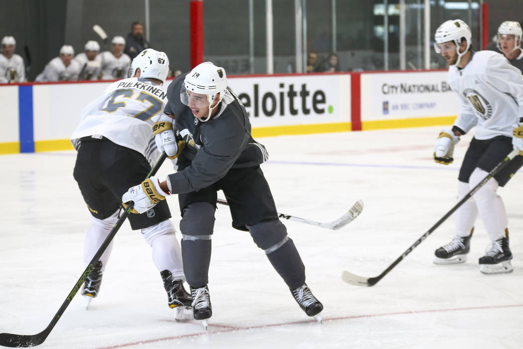Vegas Golden Knights right wing Reilly Smith, center, (19) shoots past Golden Knights left wing Temmu Pulkkinen (67) in a scrimmage game during the NHL team's practice at the City National Arena i ...