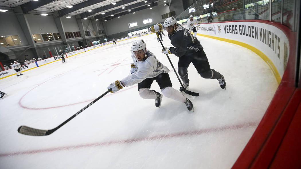Vegas Golden Knights left defenseman Brad Hunt, left, (77) and Golden Knights left wing Pierre-Edouard Bellemare (41) chase the puck in a scrimmage game during the NHL team's practice at the City  ...