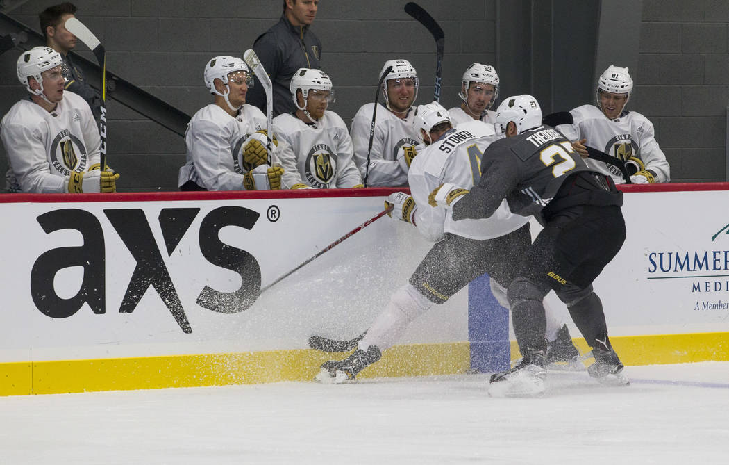 Vegas Golden Knights left defenseman Clayton Stoner (4) and Golden Knights left defenseman Shea Theodore (27) vie for the puck in a scrimmage game during the NHL team's practice at the City Nation ...