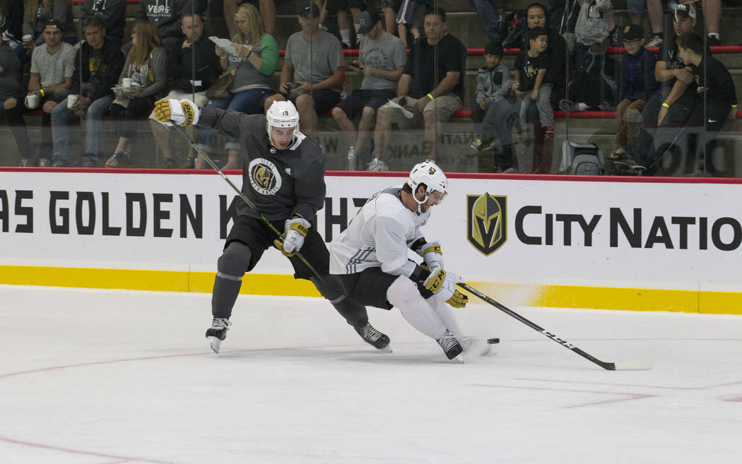 Vegas Golden Knights right wing Reilly Smith, left, (19) and Golden Knights right defenseman Colin Miller (6) vie for the puck in a scrimmage game during the NHL team's practice at the City Nation ...