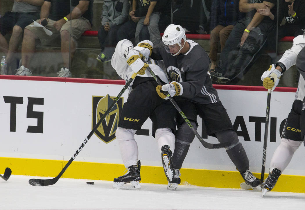 Vegas Golden Knights centerman Jonathan Marchessault, left, (81) and Golden Knights right wing Reilly Smith (19) vie for the puck in a scrimmage game during the NHL team's practice at the City Nat ...