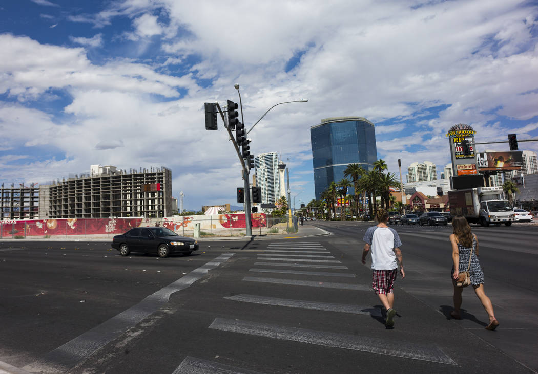 Pedestrians walk along the north Strip as construction continues at Resorts World Las Vegas, upper left, in Las Vegas on Wednesday, Sept. 13, 2017. Chase Stevens Las Vegas Review-Journal @cssteven ...