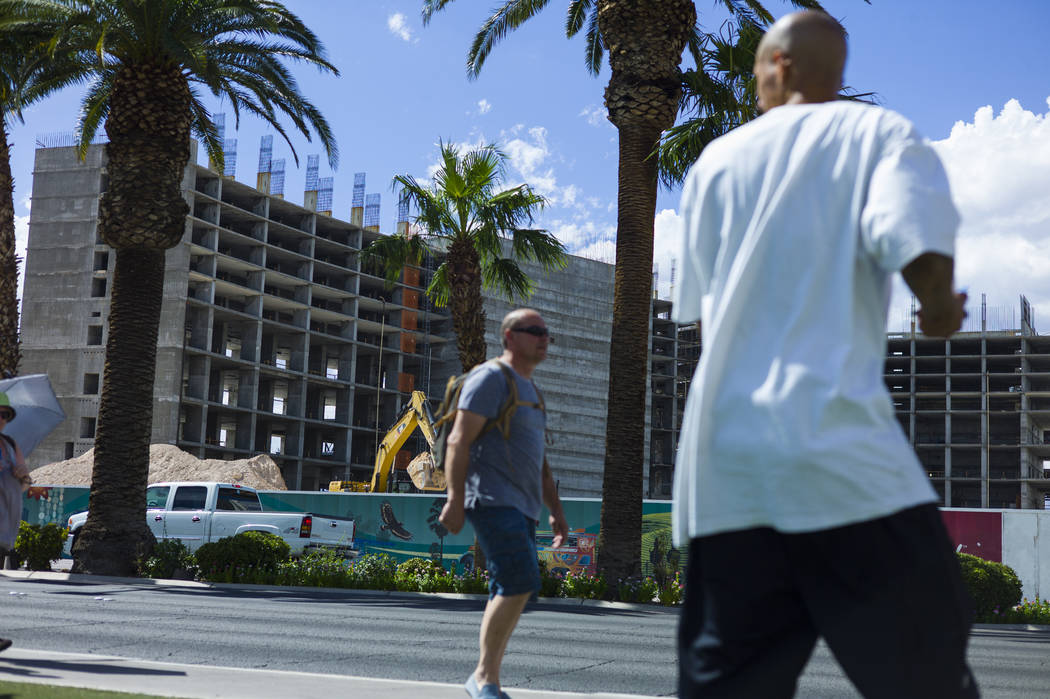 Construction continues at Resorts World Las Vegas as pedestrians pass by along the north Strip area in Las Vegas on Wednesday, Sept. 13, 2017. Chase Stevens Las Vegas Review-Journal @csstevensphoto