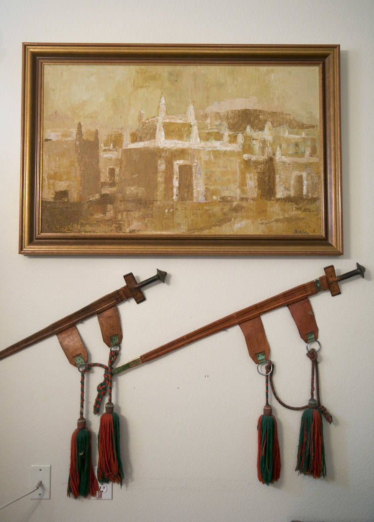 Dennis Ortwein's painting of Nigerian compound houses in Kano, Ningera and decorative swords at his home in Summerlin, Las Vegas, on Wednesday, Sept. 13, 2017. Ortwerin is one of four people who ...