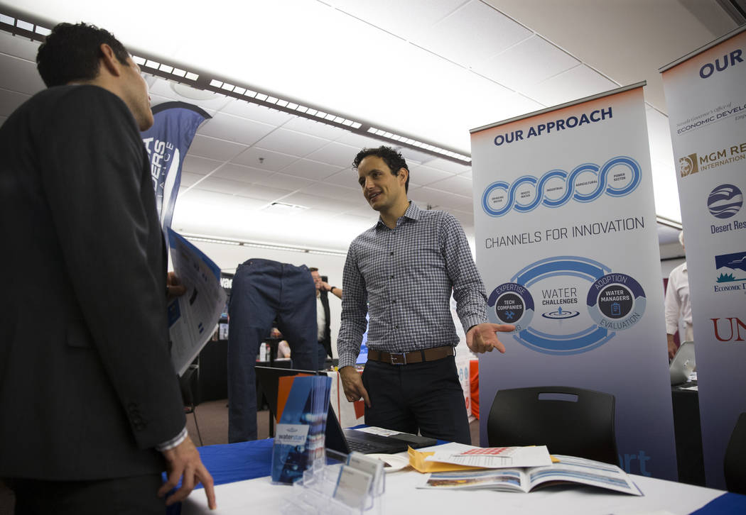 Edgar Antonio Nuñez, left, marketing manager for TSK Architects, speaks with Travis Brewer Lachapelle, technology services manager for WaterStart, during the Nevada Economic Development Confe ...