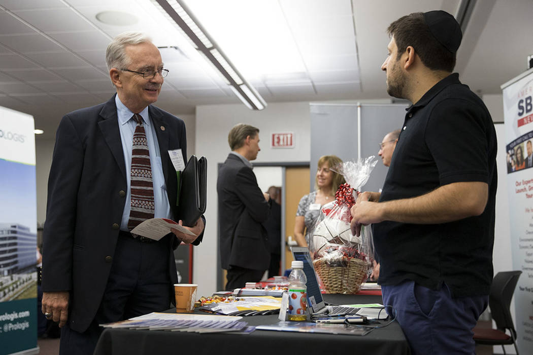 Stephen Miller, left, director of the Center for Business and Economic Research at the Lee Business School, speaks with Jake Halu of the Nevada center for Advanced Mobility, during the Nevada Econ ...