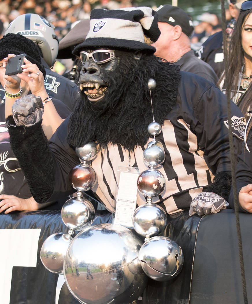 An Oakland Raiders fan cheers on the team from 'The Black Hole' during the first quarter of a NFL preseason football game against the Los Angeles Rams in Oakland, Calif., Saturday, Aug. 19, 2017.  ...