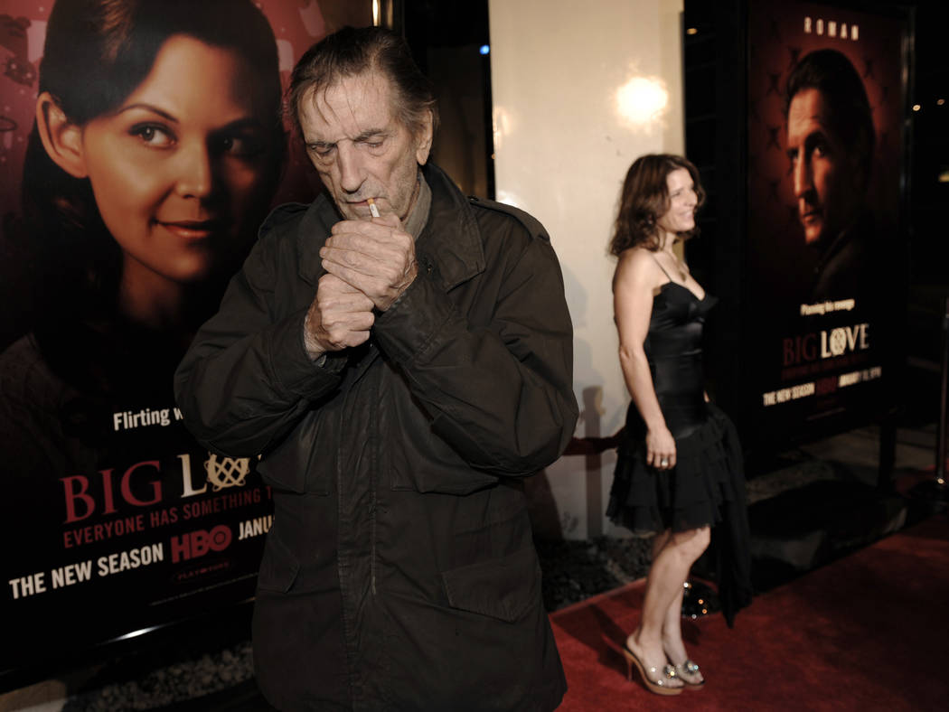 Harry Dean Stanton, left, a cast member in the HBO series "Big Love," lights a cigarette as fellow cast member Melora Walters poses on the red carpet at the show's third season premiere in Los Ang ...