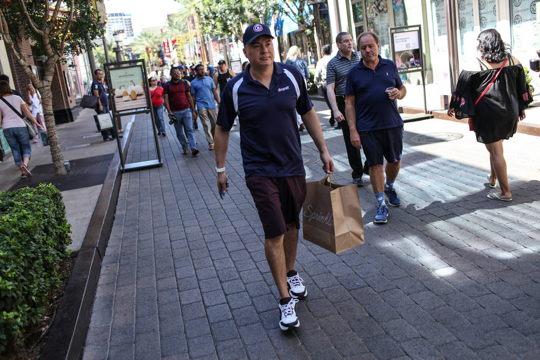 Rick Lewis, a driver for same-day delivery service Dropoff, picks up a package from Sprinkles located in The Linq Hotel Monday, Sept. 18, 2017 and takes it to his car for delivery in Las Vegas. (J ...