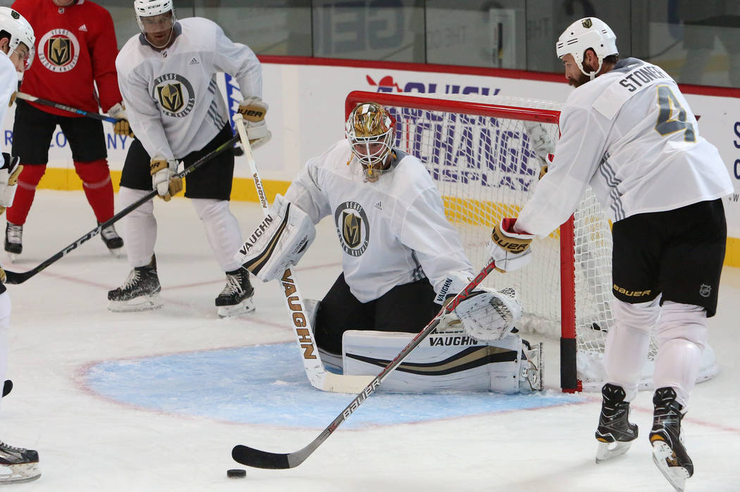 Vegas Golden Knights goalie Calvin Pickard prepares to block defenseman Clayton Stoner's (4) shot during team's practice at City National Arena on Monday, Sept. 18, 2017, in Las Vegas. Bizuayehu T ...