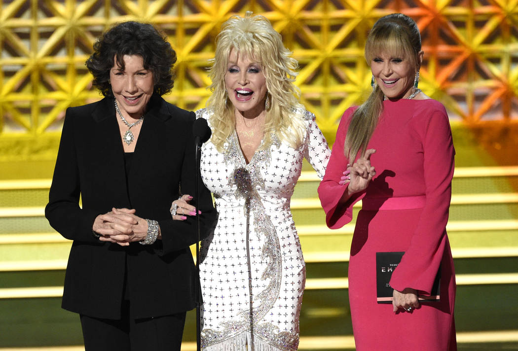 Lily Tomlin, from left, Dolly Parton and Jane Fonda present the award for outstanding supporting actor in a limited series or a movie at the 69th Primetime Emmy Awards on Sunday, Sept. 17, 2017, a ...