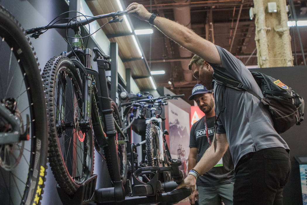 Las Vegas residents Matt Rozar, right, and Robert Hutchinson, left, check out the Thule bike racks at Interbike International Expo at Mandalay Bay Convention Center on Wednesday, Sep. 20, 2017, in ...